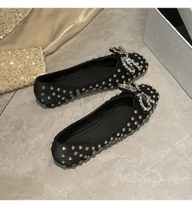 Elegant black flat shoes with full rhinestone embellishments and a sparkling bow detail