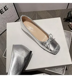 Detail view of silver French style vintage ballet flats with bowknot and glitter toe cap