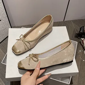 Elegant beige leather ballet flats with bow detail and hidden wedge heel for women.