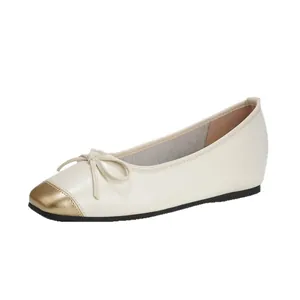 Elegant French retro cream leather flat shoes featuring a gold toe cap and bow detail