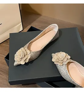Elegant sparkling silver pointed flat shoes with crystal flower detail for wedding guest.