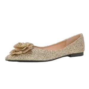 Elegant gold glitter flat shoes with floral accent and pointed toe for weddings events