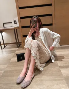 Dettaglio di ballerine con paillettes e punta quadrata in un ambiente interno elegante