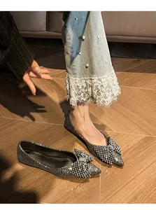 Sparkly silver sequin pointed flats featuring an elegant oversized crystal bow detail.
