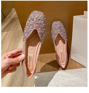 Close-up detail of pink square-toe flats with exquisite pearl and sequin decoration