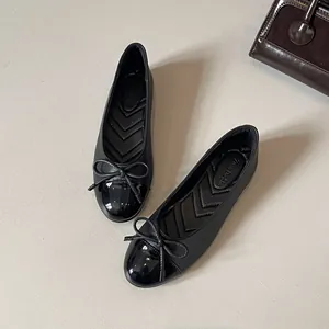 Elegant French style round toe flat shoes with bow detail and patent leather toe cap