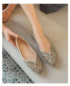 Detail of square toe flat shoes for women with elegant pearl and bead embellishment