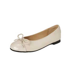 Elegant French style beige ballet flats featuring a round toe and delicate bow detail