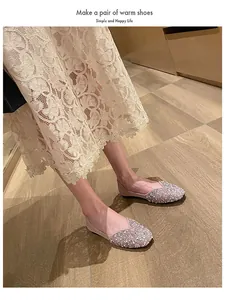 Detail view of sparkling glitter square toe flat shoes elegantly worn with a lace dress.