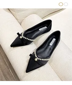 Elegant black pointed-toe flat shoes featuring delicate pearl and bow details for summer wear