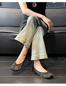Detailed macro shot of black split-toe ballet flats featuring a stylish bow knot design