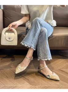 Detailed view of sparkling rhinestone pointed-toe flat sandals with elegant ankle straps.