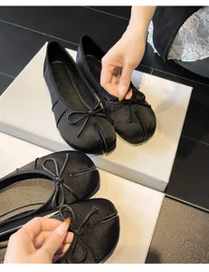 Elegant black silk tabi ballet flats featuring delicate bow and split toe detail