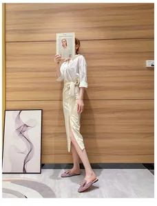 Model wearing sparkling rhinestone flat mules in a modern indoor setting