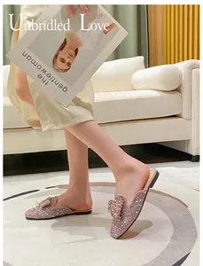 Lifestyle macro detail view of sparkly rhinestone bow mules for women on a model