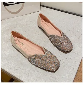 Detailed view of elegant square toe flats with sparkling pearl and sequin embellishments.