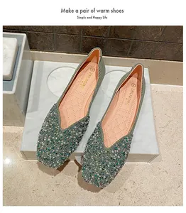 Detailed view of women's square-toe flat shoes with elegant pearl and bead embellishments.