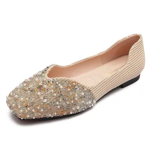 Elegant square-toe flat shoes with pearl and crystal embellishments, beige color.