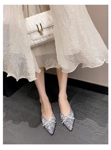 Elegante silberne Pailletten-Ballerinas mit spitzer Kappe und feinem Schleifenakzent