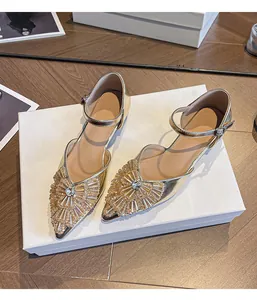 Elegant pointed-toe gold sandals with exquisite rhinestone decoration and ankle strap.