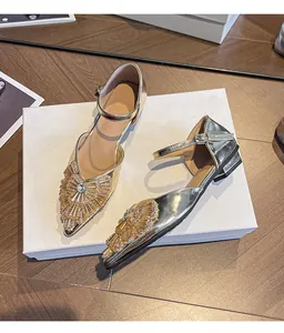 Elegant gold pointed-toe low heel sandals with sparkling rhinestone bow and ankle strap