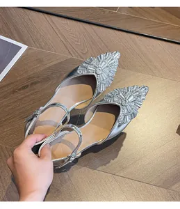Close-up detail of silver pointed-toe heels with luxurious rhinestone embellishments