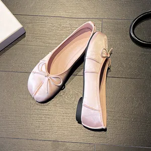 Elegant pink Tabi ballet flats for women featuring bow detail and a soft satin finish