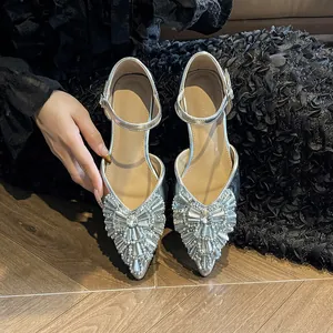 Elegant silver pointed-toe flat sandals with sparkling rhinestones and ankle strap.