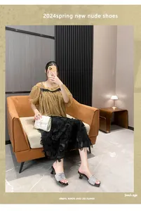 Elegant French style silver rhinestone high-heeled sandals worn by model in interior.