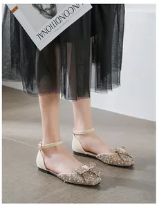 Detailed view of elegant square toe flats adorned with rhinestones and a delicate bow.
