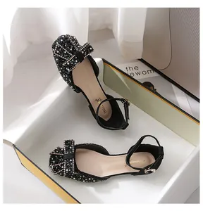 Elegant black square-toe flats with rhinestone bow and pearl details.