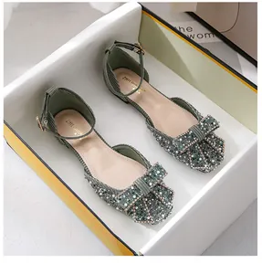 Detail of green square toe flats with rhinestones, pearls and a stylish bow accessory.
