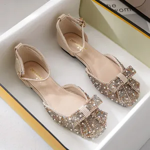 Elegant beige square toe flat shoes featuring a rhinestone bow and adjustable ankle strap