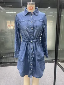 Detailed front view of a long sleeve denim shirt dress with drawstring waist on mannequin