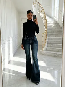 Modella che indossa jeans a zampa a vita bassa blu scuro retrò in un interno di lusso