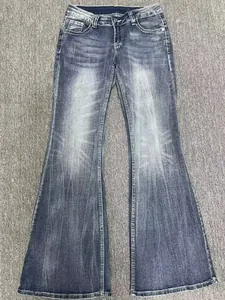 Vintage washed blue denim flare jeans featuring distressed details and floor-length cut