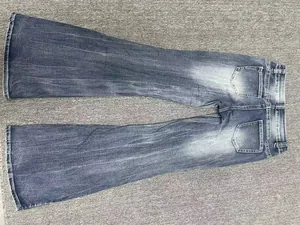 Detailed back view of vintage wash blue low-rise flared jeans in a slim fit style.