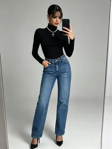 Full-body view of model in classic high-waisted washed blue straight-leg jeans