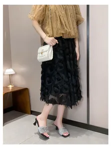 Elegant silver rhinestone high heel slides worn by a model in a stylish outfit.