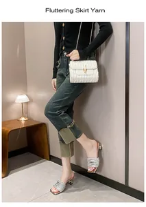 Elegant silver rhinestone high-heeled sandals shown in a lifestyle fashion setting.