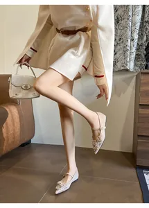 Elegant pointed toe Mary Jane flats with floral and rhinestone details in beige.