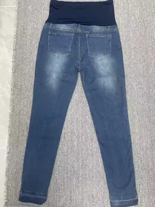 Back view of comfortable maternity skinny jeans featuring a navy elastic belly support band