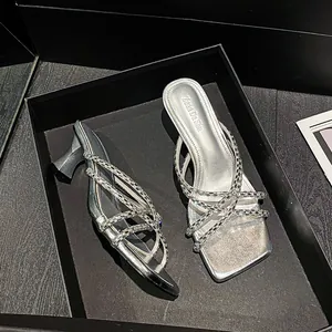 Elegant silver high heel slides with rhinestone straps in a luxury black gift box.