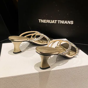 French style gold rhinestone mules featuring kitten heels and shimmering crisscross straps