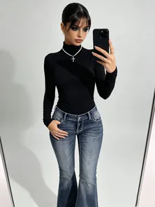 Elegant model wearing vintage wash low-waist flared jeans with a slim fit silhouette