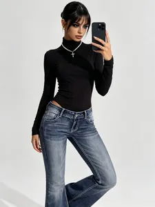 Detailed pose showing the slim-fit silhouette of vintage wash low-rise flare jeans