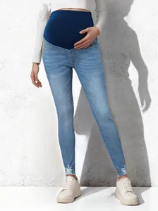 High elastic maternity skinny jeans with belly support in light blue wash on model