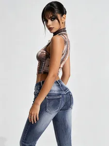 Woman in vintage washed low-waist flare jeans with slim fit and bootcut silhouette