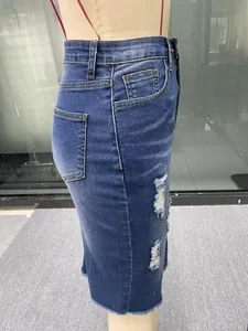 Detail view showing side profile of high waist distressed denim midi skirt with raw hem