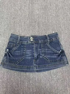 Close-up of vintage distressed blue denim shorts with pocket details on grey background